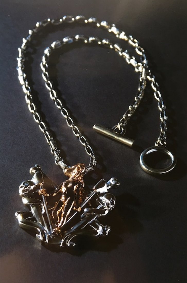 Silver chain necklace with a sculpted pendant