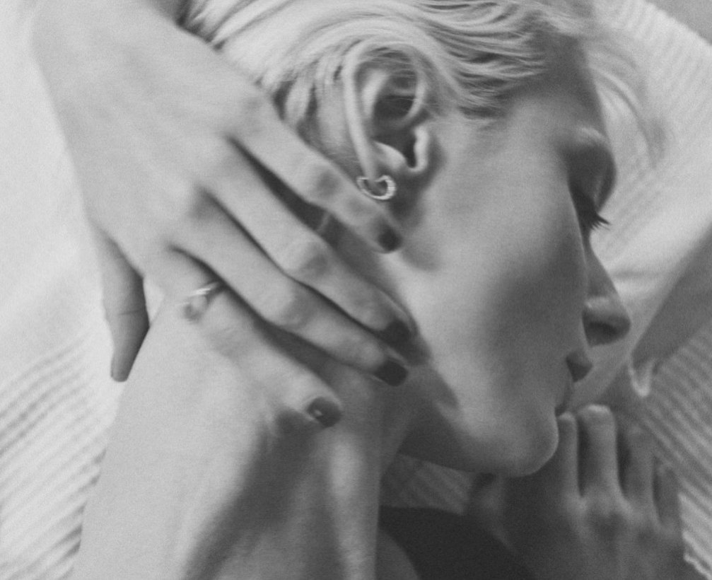 Black-and-white portrait with ear cuff and rings