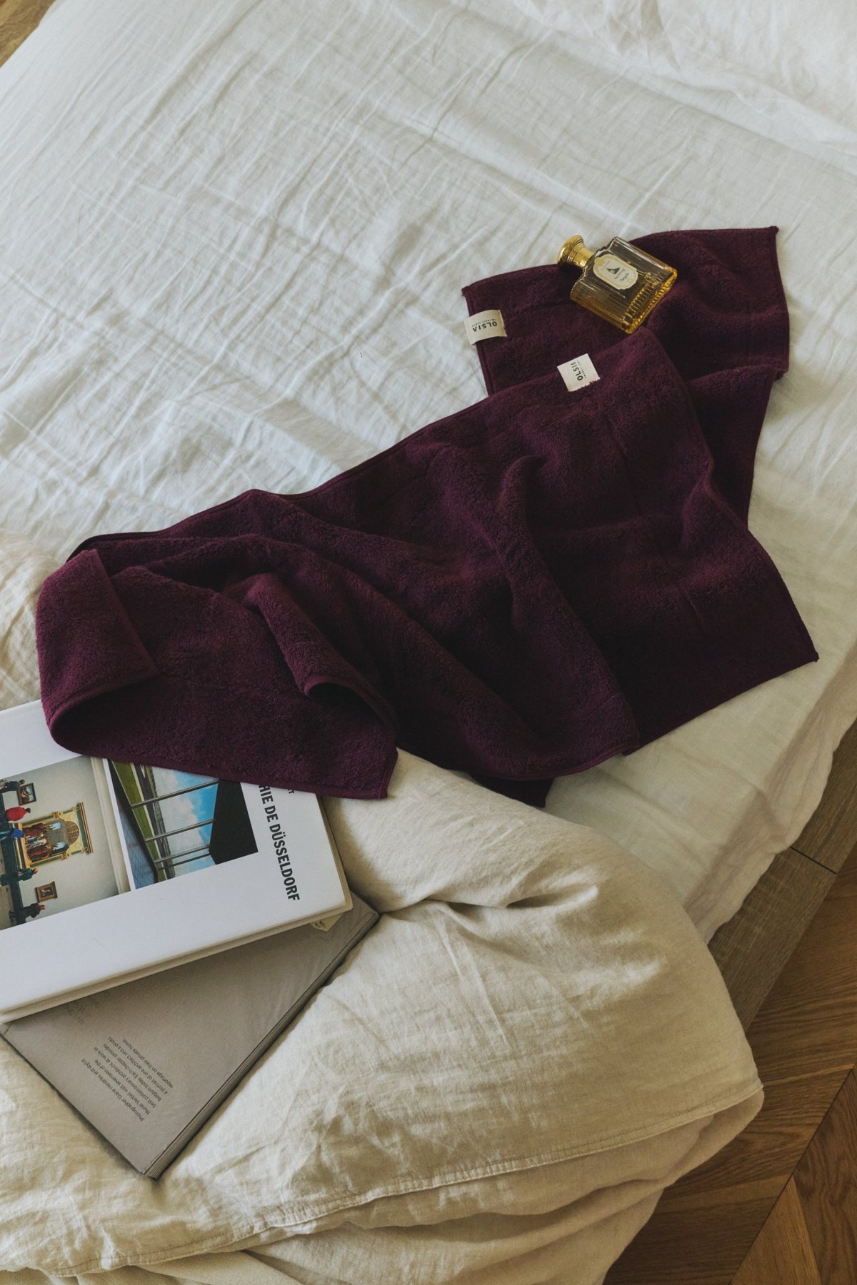 Plum towels on a linen bed