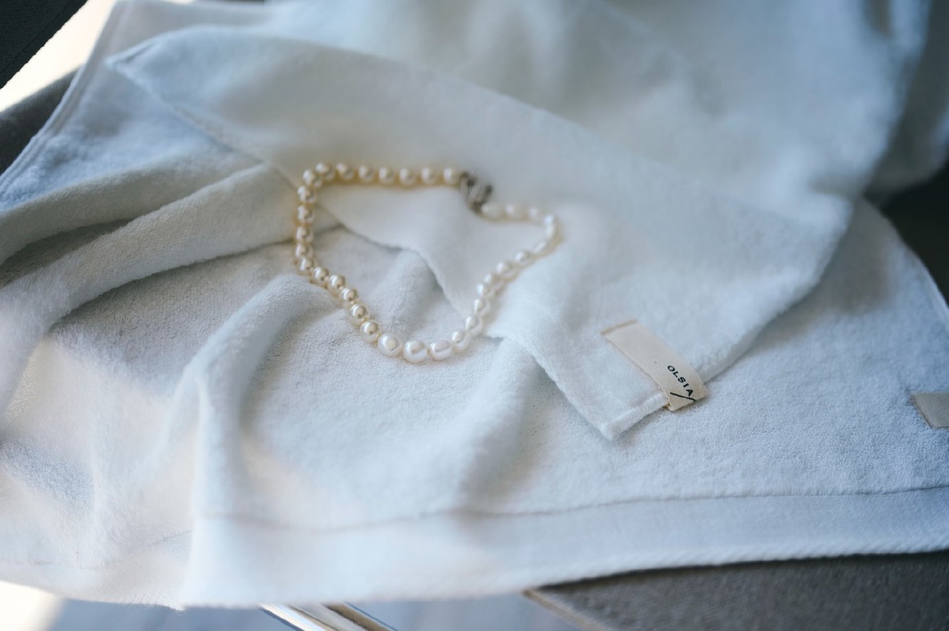 Pearl necklace on a white terry towel